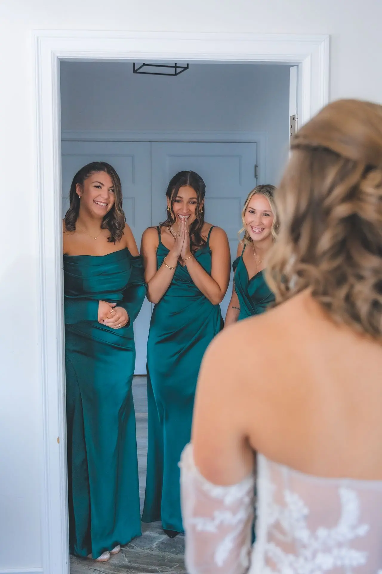 Group of bridesmaids in pastel dresses laughing – candid bridal party photography